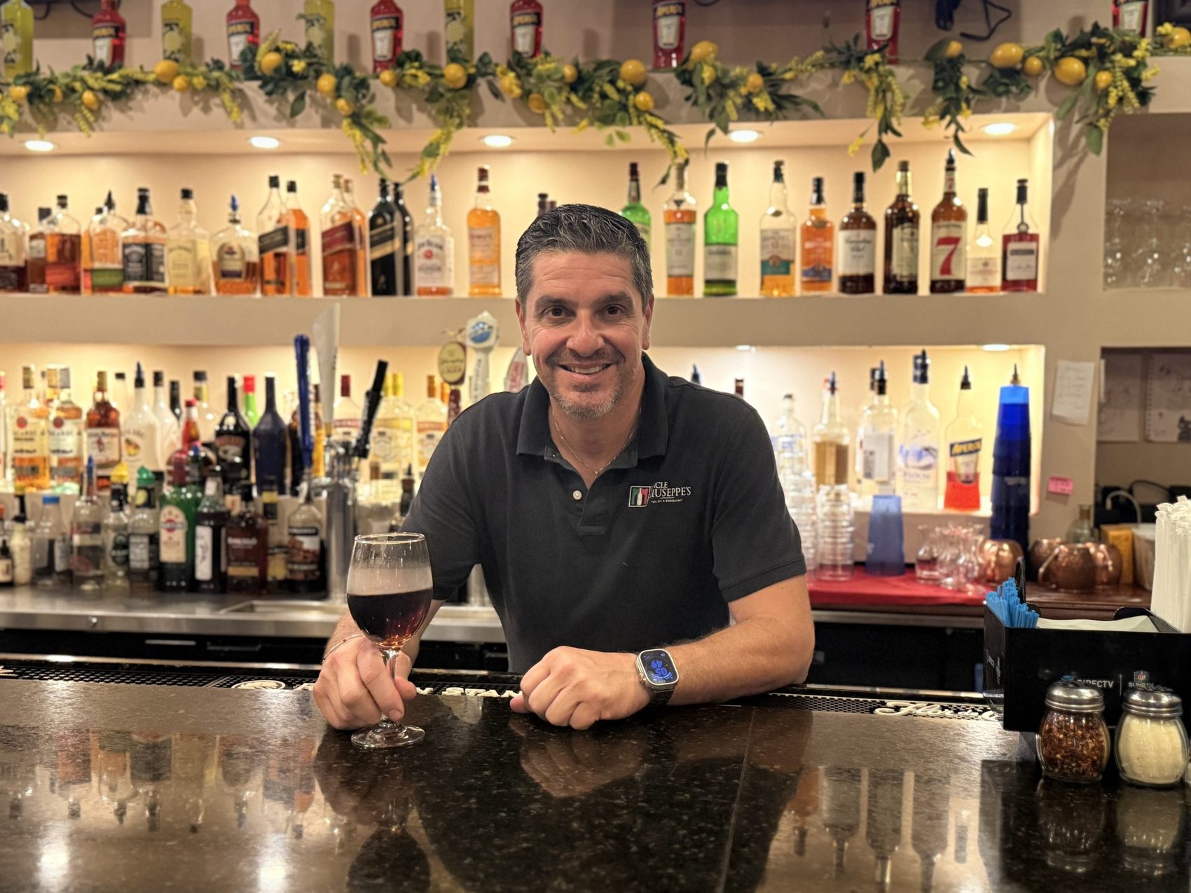 Behind the bar at Uncle Giuseppe's, beneath a garland of fresh lemons