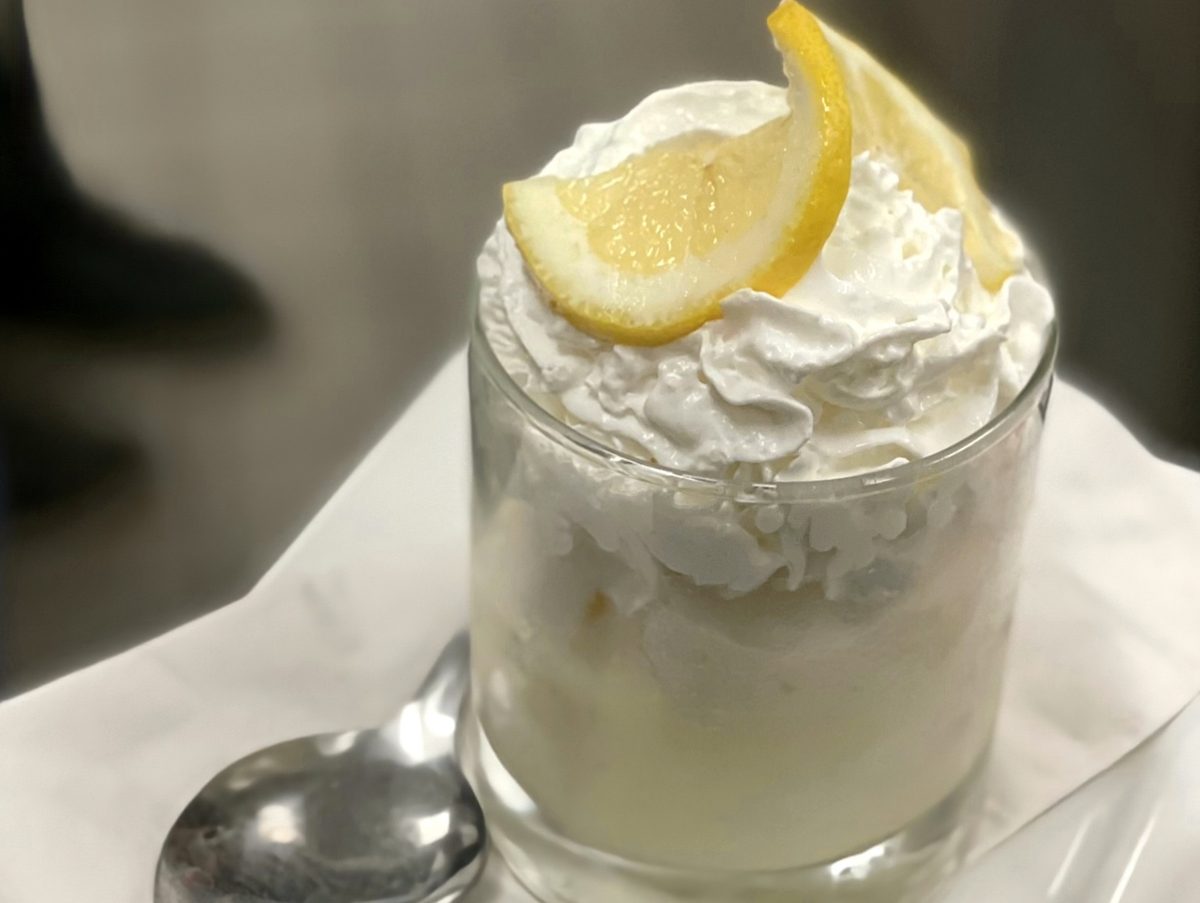Limoncello sorbet with whipped cream and a lemon wedge